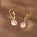 Detail of gold-plated lever-back earrings featuring a round four-prong zircon setting - Gold