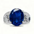 Luxurious silver ring with large oval blue gemstone and side diamond accents on white background - Adjustable Open / Blue Gemstone Style (QHJ008)