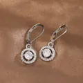 Detailed close-up of silver lever-back earrings with sparkling round cubic zirconia - Silver