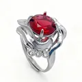 Detail view of flower petal silver ring with red oval gemstone and accent diamonds - Ruby Style / White Gold Plated Ruby Red Zirconia