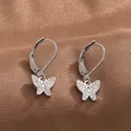 Detail of silver leverback earrings with pavé-set zircon butterfly charms on silk - White Gold