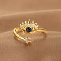 Detailed close-up of Evil Eye adjustable ring with blue sapphire and white zircon gems - Evil Eye Crown Style (Q-J083) / Gold