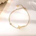 Close-up of 18K gold-plated cross bracelet with sparkling round zircon stone detail - Gold Cross Bracelet (XKB0037)