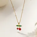 Golden cherry pendant necklace with red and green zircon crystals on beige background - Mixed Size Cherry Style (XKN8244) / Gold