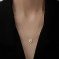 Elegant 18k gold-plated pearl flower pendant necklace for women shown on neck - Pearl Flower Necklace / Gold