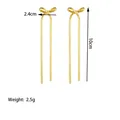 Detailed view of gold tassel bow earrings with 10cm flat snake chain and size markings - Gold