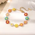 Close-up of a colorful enamel daisy flower bracelet with a golden link chain and clasp - Colorful Daisy Anklet / Gold