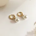 Detailed view of 18K gold plated hoop earrings with elegant white pearl charms - Pearl Hoop Earrings (Gold)