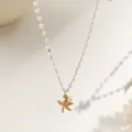 Detail of beach-style pearl necklace featuring a matte gold starfish pendant and single pearl - Pearl Starfish Necklace / Gold