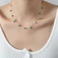 Elegant gold chain necklace with natural turquoise stone beads on female model - Turquoise
