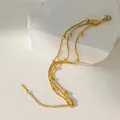 Detailed shot of multi-layer gold stainless steel beaded bracelet on a textured stone - 3-Layer Bead Bracelet / Gold