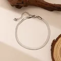 Elegant silver snake chain bracelet in titanium steel on a natural wood background - 4mm / Steel