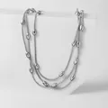 Detail of silver triple-layered snake chain necklace with polished metal beads - Steel Color Multi Layered Necklace (XKN6092)