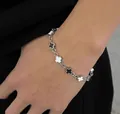 Französisches Modearmband mit schwarz-weißen Kreuzsternen aus Edelstahl für Damen - 19cm / Schwarz und Weiß