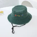 Close-up of children bucket hat featuring excavator embroidery and adjustable windproof rope - 54cm / Green