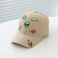Detailed close-up of cartoon alien and UFO embroidery on a khaki cotton kids baseball cap - Small/Adjustable / Khaki