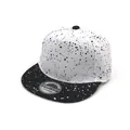 Detail of kids snapback hat with black and white ink splatter pattern and flat brim - 50-54cm / White