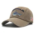 Detail of shark embroidery and American flag patch on washed khaki canvas baseball cap - Khaki