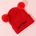 Close-up of red knit hat with dual faux fur pom-poms and cute embroidered eyelashes - One Size / Red