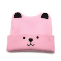 Close-up of pink knit baby beanie with black 3D ears and cute cartoon animal face - One Size / Pink