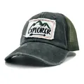Close-up of vintage washed cotton baseball cap with distressed brim and explorer patch - Dark Green
