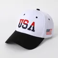 Detail of embroidered USA letters and American flag patch on classic baseball cap - White