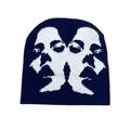 Detailed view of navy blue and white knit beanie featuring an abstract face sketch pattern - One Size / Navy Blue