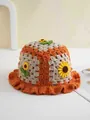 Detailed view of handmade crochet sunflower bucket hat with wave pattern knit texture - 56-59cm / Orange