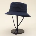 Close-up of waterproof navy bucket hat with adjustable chin cord and breathable eyelets - Adjustable / Navy Blue