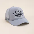 Close-up of light blue trucker hat featuring star embroidery and breathable mesh texture - Adjustable / Gray