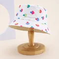 Detail of white cotton bucket hat with colorful mushroom print on a wooden stand - Kids 54cm / Mushroom Style 1 White