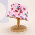 Detailed view of pink cotton sun hat with watercolor strawberry print on wooden stand - Kids 54cm / Strawberry Pink