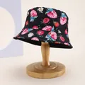 Kids black bucket hat with strawberry and flower print on a wooden stand for sun protection - Kids 54cm / Black Strawberry