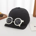 Detail of children's baseball cap with integrated sunglasses on a minimalist background - Infant Style / Black