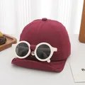 Detail of burgundy kids baseball cap with integrated white round sunglasses decoration - Infant Style / Burgundy