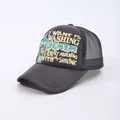 Macro detail of charcoal grey trucker hat with breathable mesh and vintage typography - Adjustable / Gray