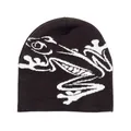Close-up of fine black knit texture with white abstract frog jacquard pattern detailing - Brown