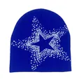 Detail of the blue knit beanie featuring a white star pattern and fine jacquard texture - Blue