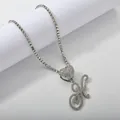 Macro detail of silver tennis chain with heart pendant and iced out letter K charm - Silver Set K