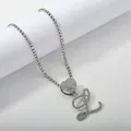 Macro detail of silver tennis chain with heart and cursive letter L pendant and zircons - Silver Set L