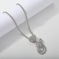 Macro shot of silver tennis necklace with iced out heart and script letter S pendant - Silver Set S