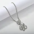 Macro detail of silver hip hop tennis chain with iced out heart and cursive letter pendant - Silver Set U