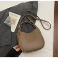 Detail of khaki leather hobo bag with pebble texture and adjustable shoulder strap - Brownish Gray
