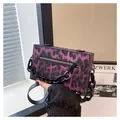 Close-up of purple leopard print box clutch bag with thick black chain and zipper detail - Purple