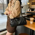 Black pleated Boston bag with gold eyelet straps and metallic buckles for daily fashion - Standard Type / Black