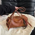 Brown vintage Boston shoulder bag with textured leather and gold eyelet buckle straps - With Pendant / Yellow Brown