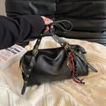 Matte black Boston bag with gold eyelet straps and braided tassel detail - With Pendant / Black
