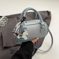 Light blue mini boston bag with lychee texture leather and a rocking horse pendant - With Charm / Blue