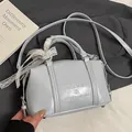Light blue Boston pillow bag with embossed logo and decorative white lace bow - No Pendant / Blue