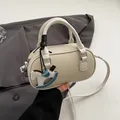 Chic cream white lychee texture Boston mini handbag with a cute rocking horse charm - With Charm / Off White